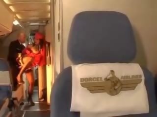 Passionate stewardess rides a penis inside both holes