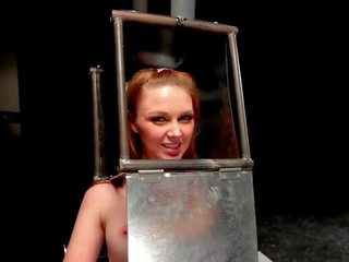 BDSM feature with head in steel box spaked